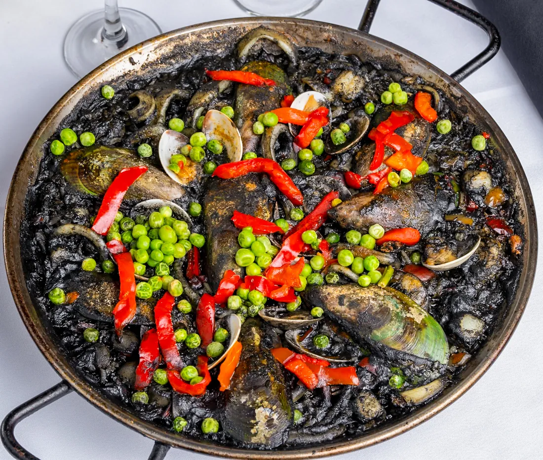 Paella negra, black rice cooked in squid ink with seafood at Los Gallegos Miami