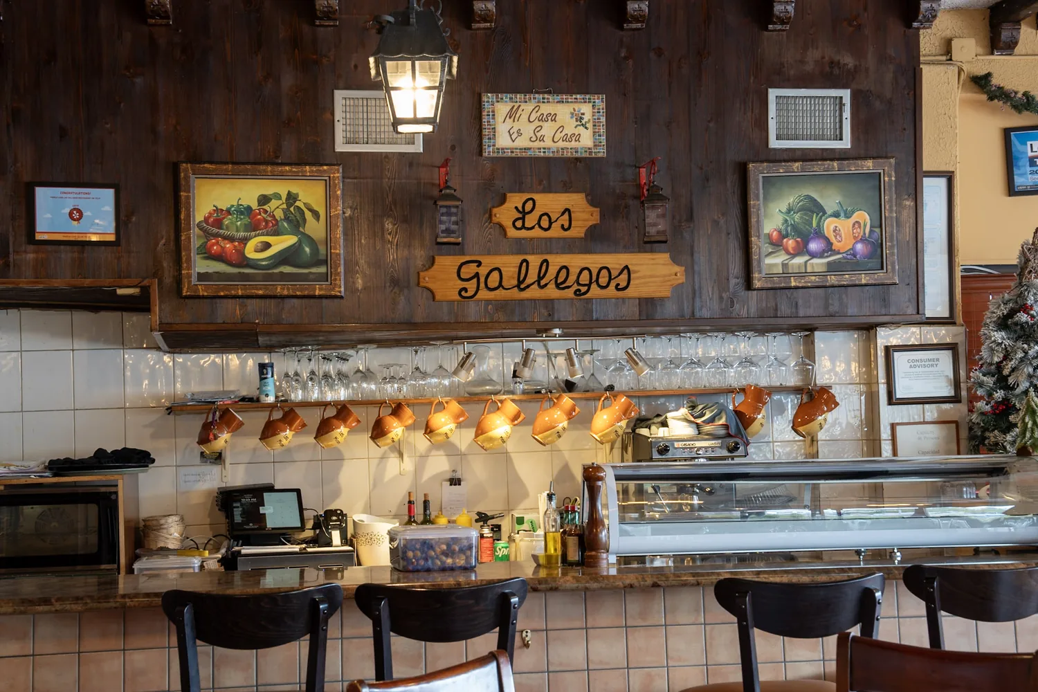 The bar and hand-painted Los Gallegos sign inside the Spanish restaurant in Miami, Florida
